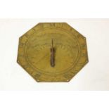 An octagonal brass sundial,