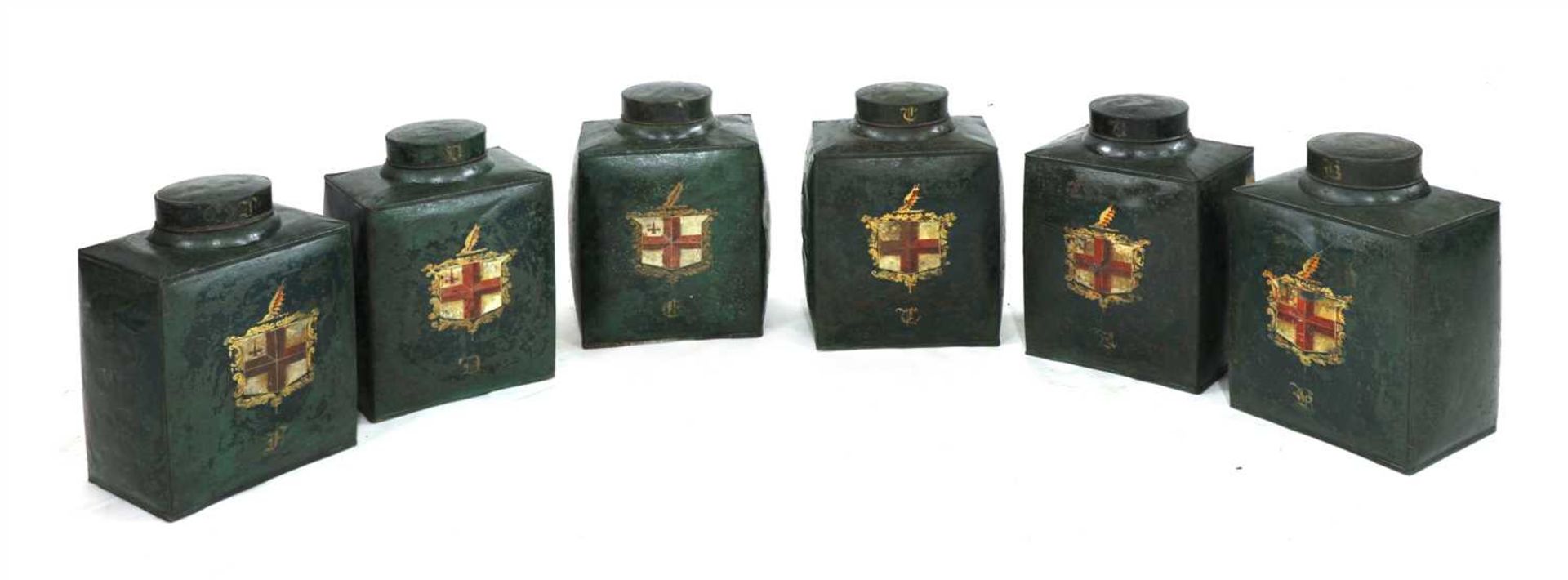 A SET OF SIX BOMBÉ-SHAPED TOLEWARE TEA CANISTERS,