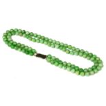 A two row uniform jadeite bead necklace,