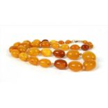 A single row graduated oval butterscotch amber bead necklace,