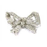 A diamond set bow brooch,