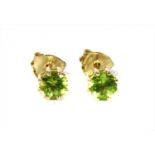 A pair of gold single stone peridot stud earrings,