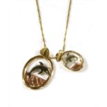 Two three colour gold openwork dolphin pendants,