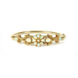 A 9ct gold opal bangle,