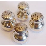 Four small and squat baluster-shaped white metal pepperettes (some dents, discolouration etc.