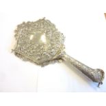 A very heavy ornate Victorian hand mirror profusely decorated with cherubs etc.