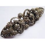 An Art Deco style white metal and marcasite-mounted clip brooch