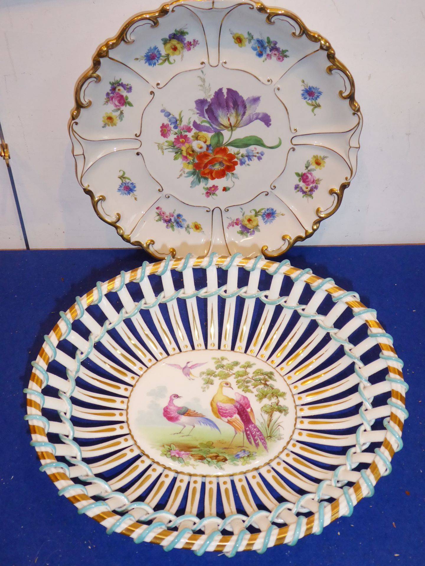 A pierced latticework chestnut basket hand-decorated in enamels with exotic birds amongst country