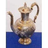 A 19th century hallmarked silver coffee pot; the body decorated in repoussé style with flower heads,