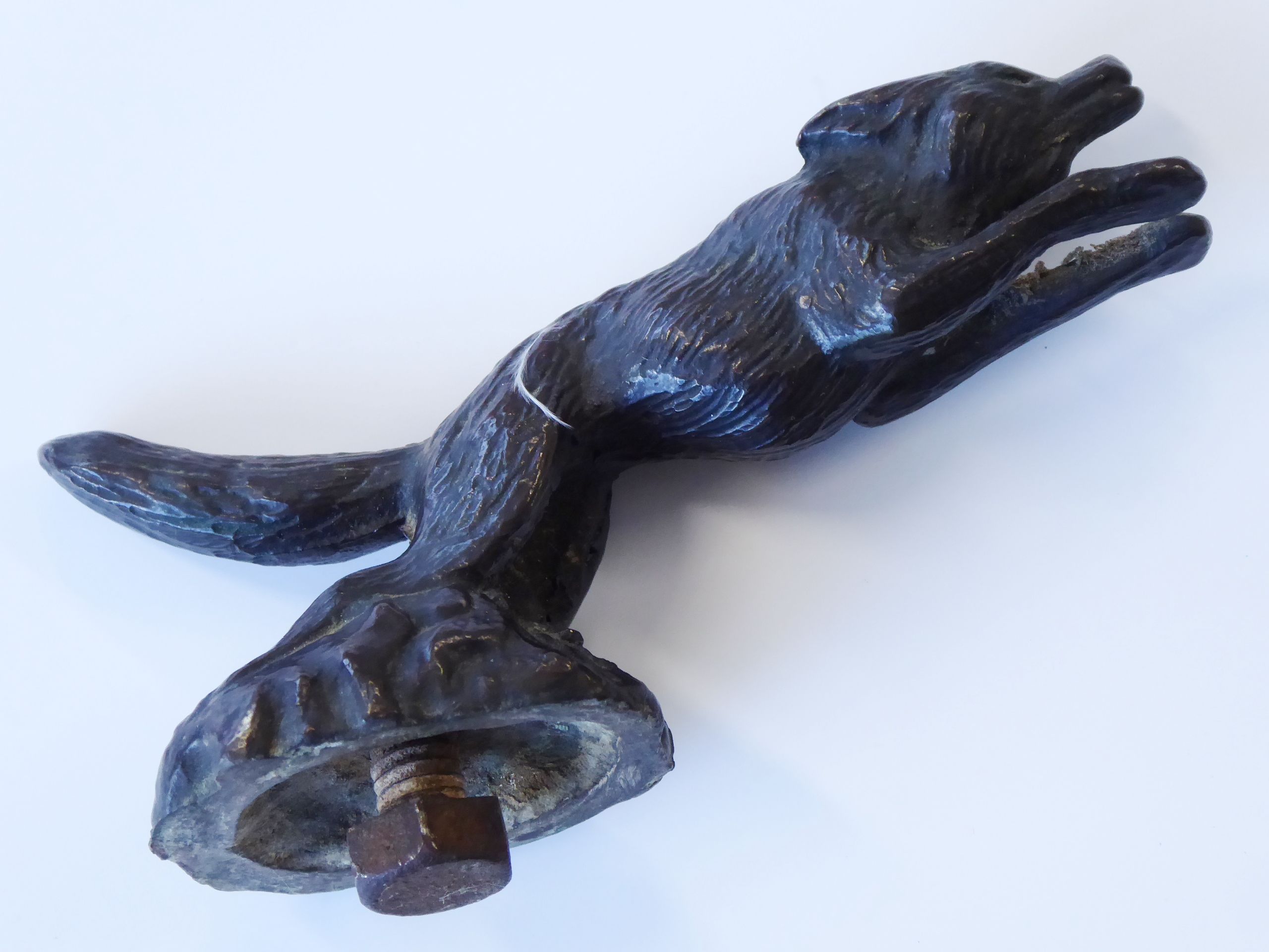 An early 20th century patinated bronze car mascot modelled as a leaping fox, 10.