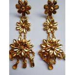 A pair of Indian yellow metal drop earrings decorated with flower heads, droppers etc., approx. 19.