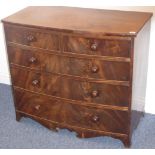 An early 19th century bow-fronted mahogany chest of small proportions;