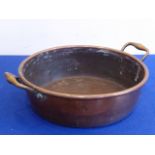 A large and heavy 19th century circular copper two-handled preserve pan,