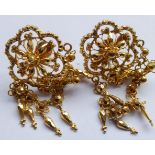 A pair of Indian yellow metal drop earrings headed by flower heads with droppers below, approx. 17.