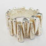 A heavy modernist-style silver ring modelled with vertical textured and untextured reeding