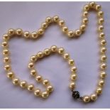 A single string of 6mm vintage pearls with paste clasp; approx.