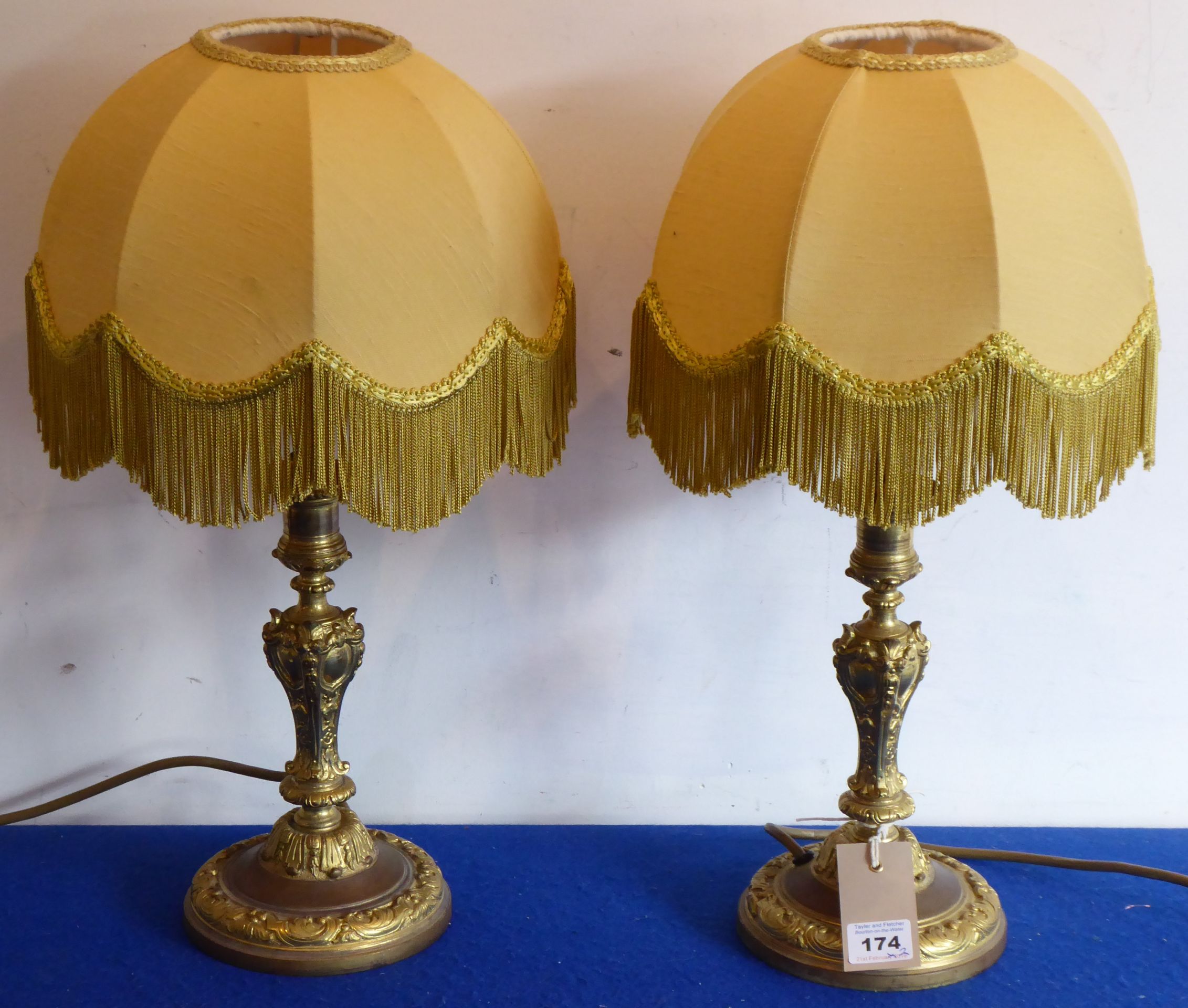 A pair of gilt-metal candlesticks in 19th century style (now as table lamps with shades)