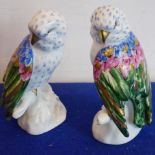 A pair of hand gilded and decorated Portuguese porcelain models of parrots,