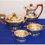 A four-piece hallmarked silver tea service comprising teapot, hot water jug,