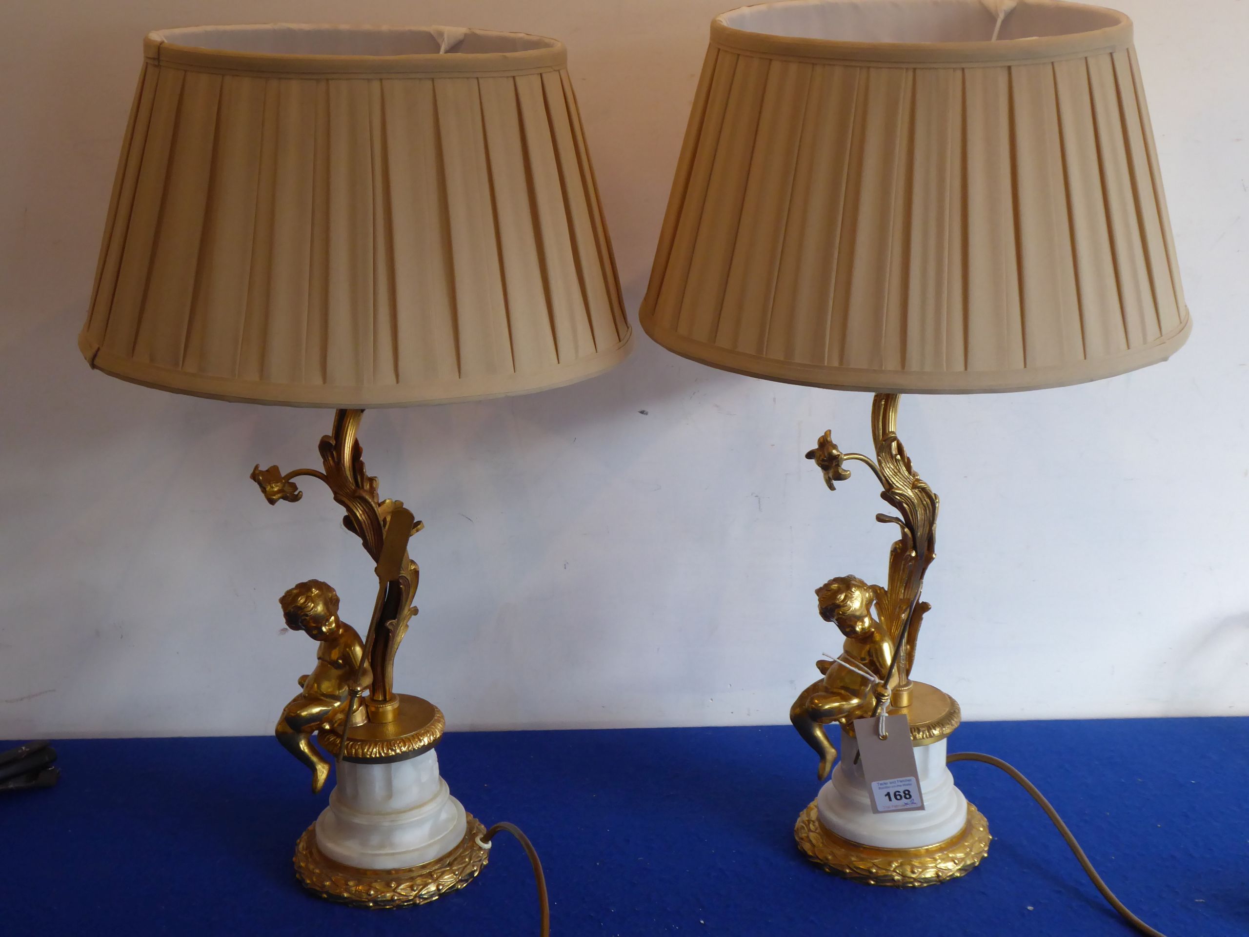 A highly decorative pair of French-style gilt-bronze table lamps and shades;