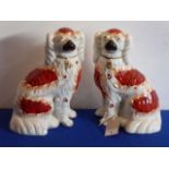 A pair of 19th century Staffordshire spaniels with russet markings,