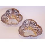A pair of early 20th century trefoil-shaped hallmarked silver bon bon baskets with pierced sides