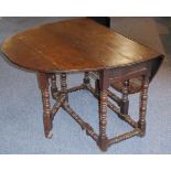 A late-17th century oval oak drop-leaf gateleg table;