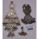 An ornate Indian white metal clip,