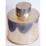 A hallmarked silver tea caddy of oval form;