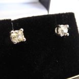 A pair of 18-carat white gold ear studs set with 1920 old cut solitaire diamonds,