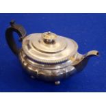 A hallmarked silver teapot of squat lobed melon form;