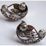 A pair of antique white-metal earrings fashioned in a swirl design;