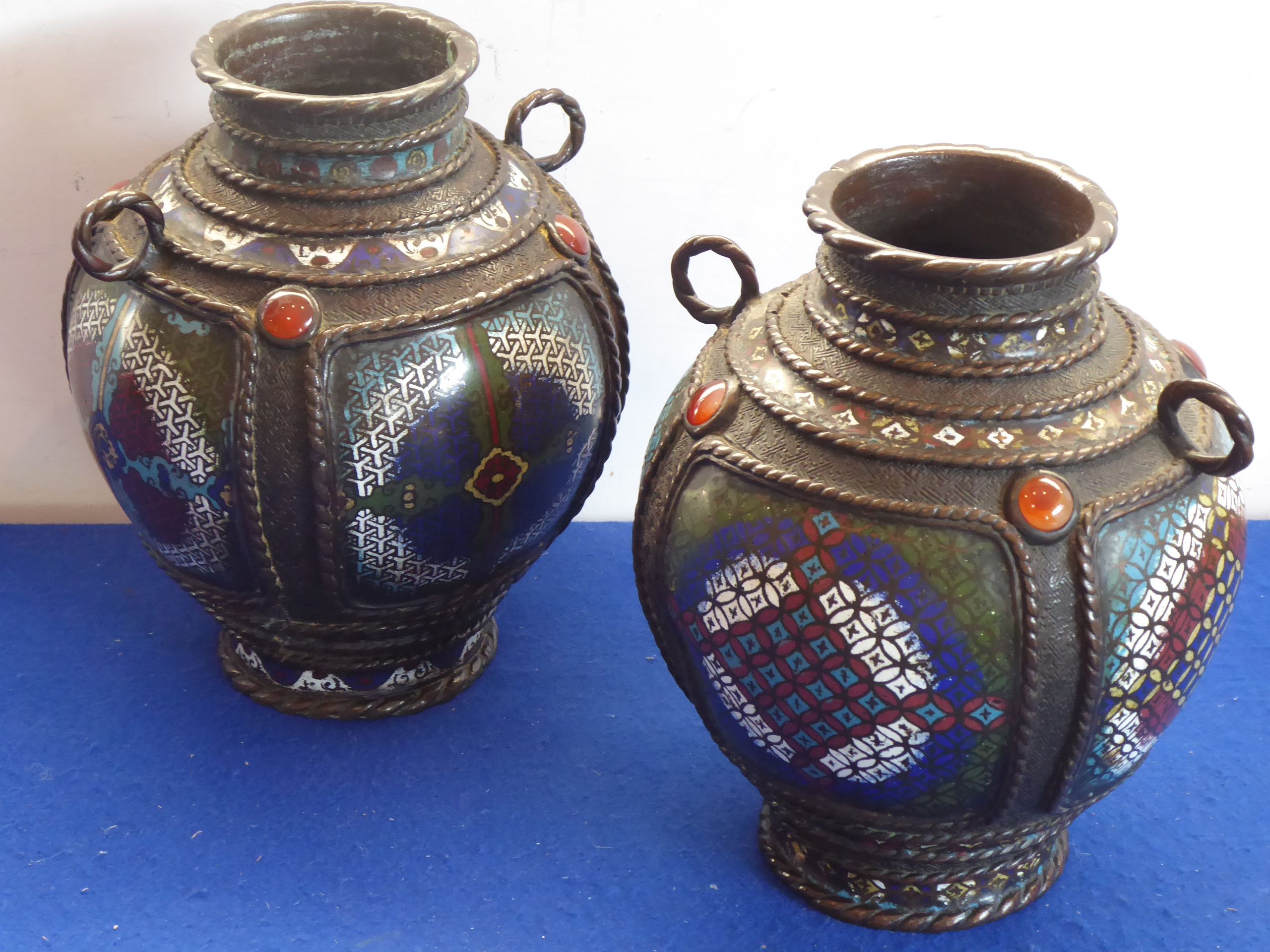 A pair of heavy Oriental bronze and enamel ovoid vases; each with two ring-handles,
