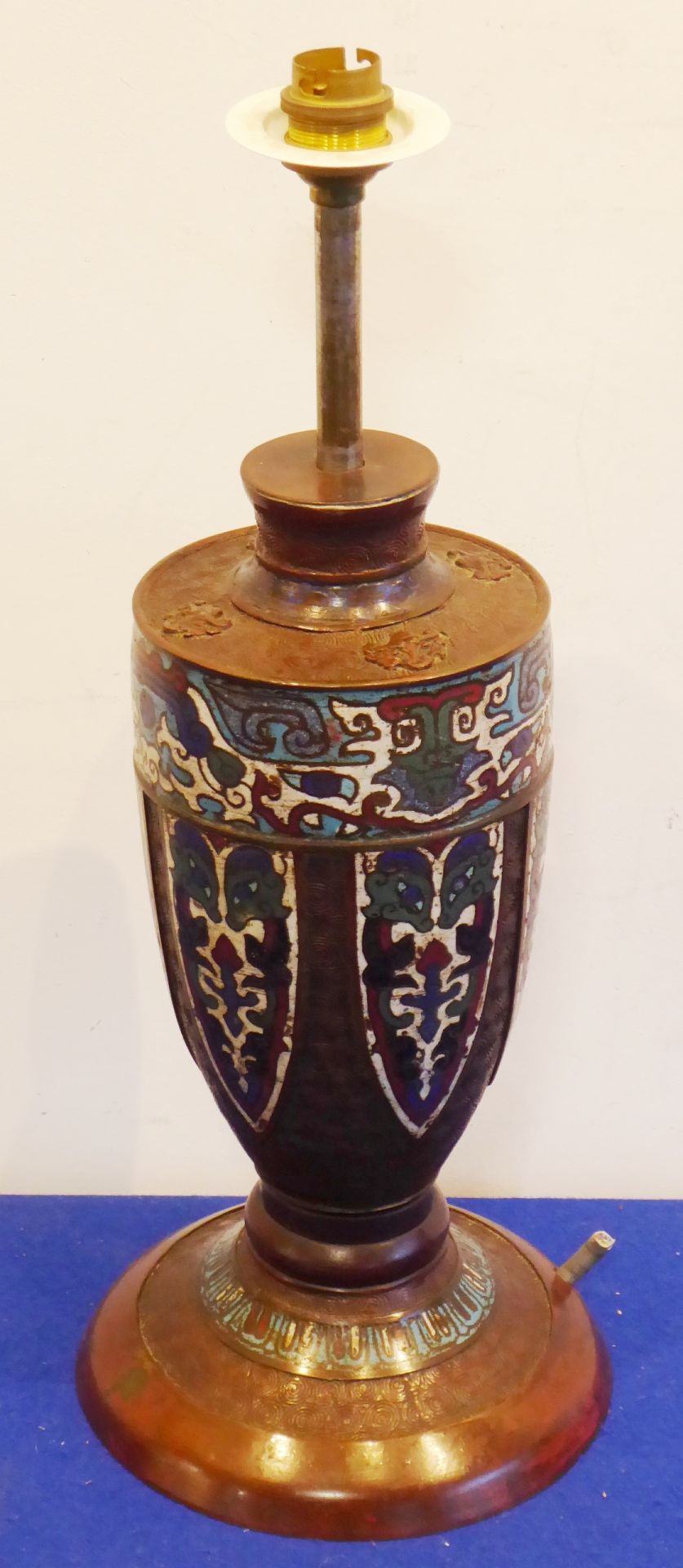 An Oriental bronze and enamel lamp base;