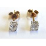 A pair of solitaire diamond ear studs (over 0.