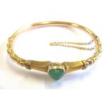 A heavy 18-carat gold bangle set with heart-shaped chalcedony CONDITION REPORT: