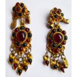 A pair of yellow metal clip earrings with 'trailing flame' decoration in relief and mounted with