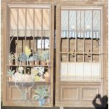 A pair of large hand-painted wooden-framed linen and chickenwire panels depicting displays of