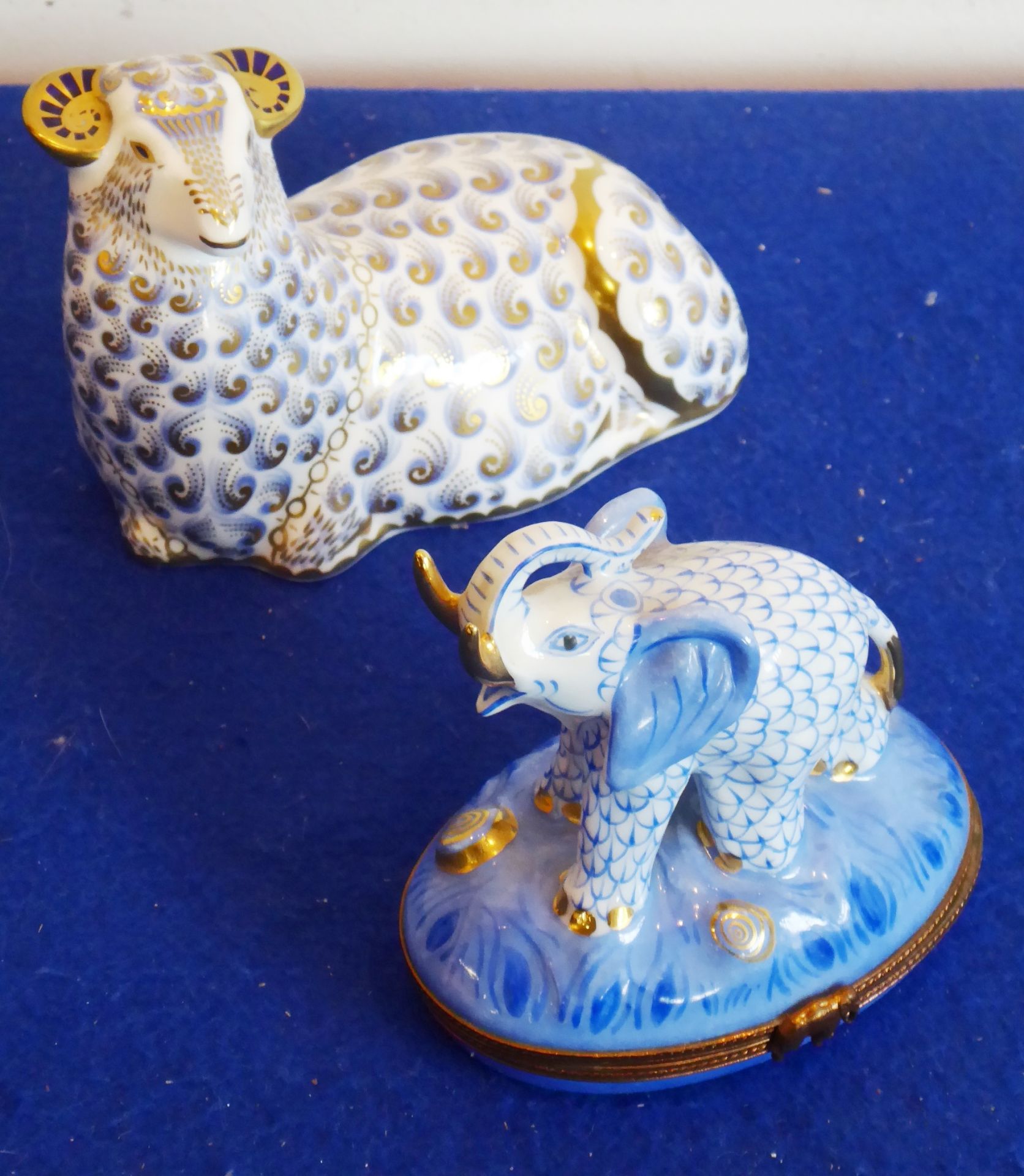 A Royal Crown Derby paperweight modelled as a recumbent ram ('gold button'),