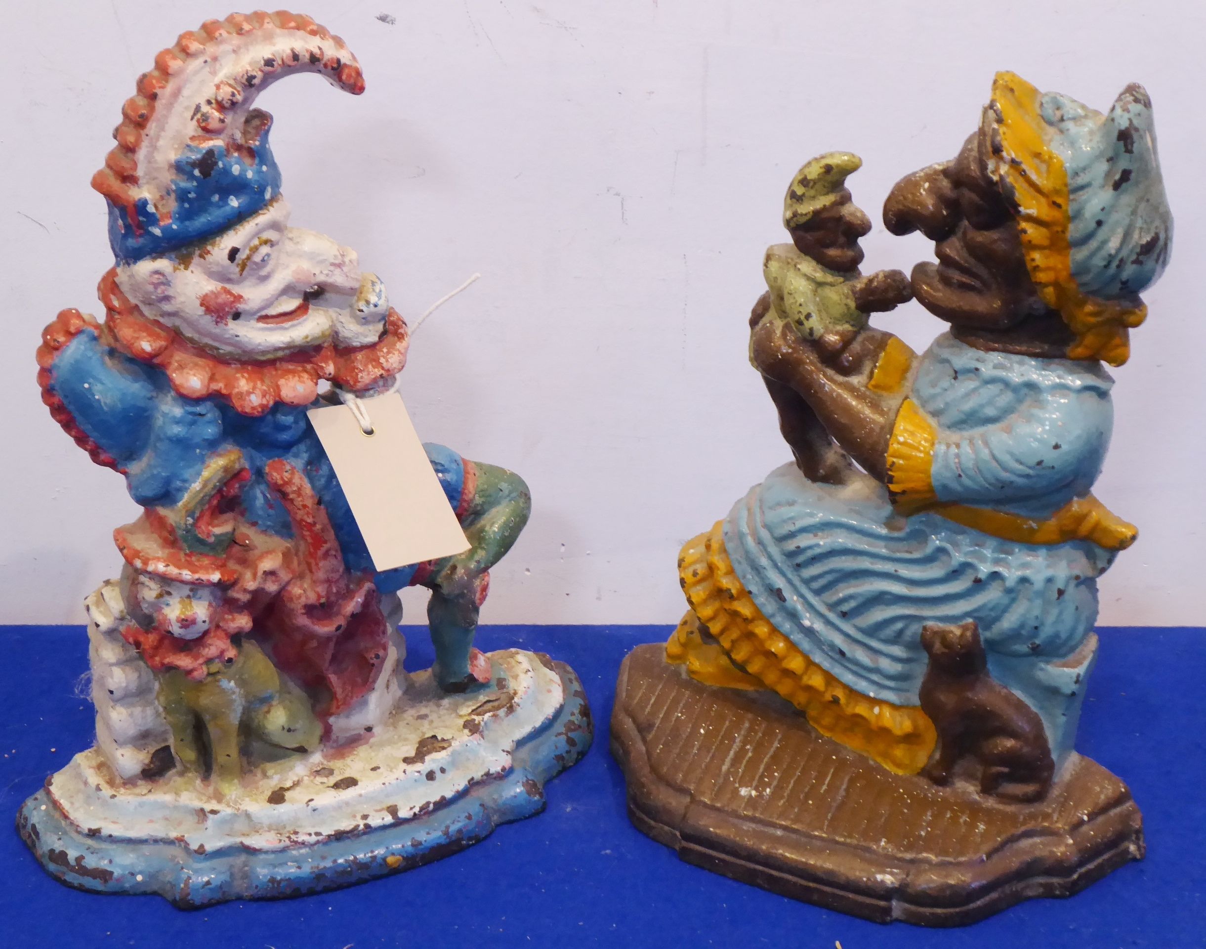 Two cast iron 19th century hand-painted door stops, Punch and Mrs Punch,