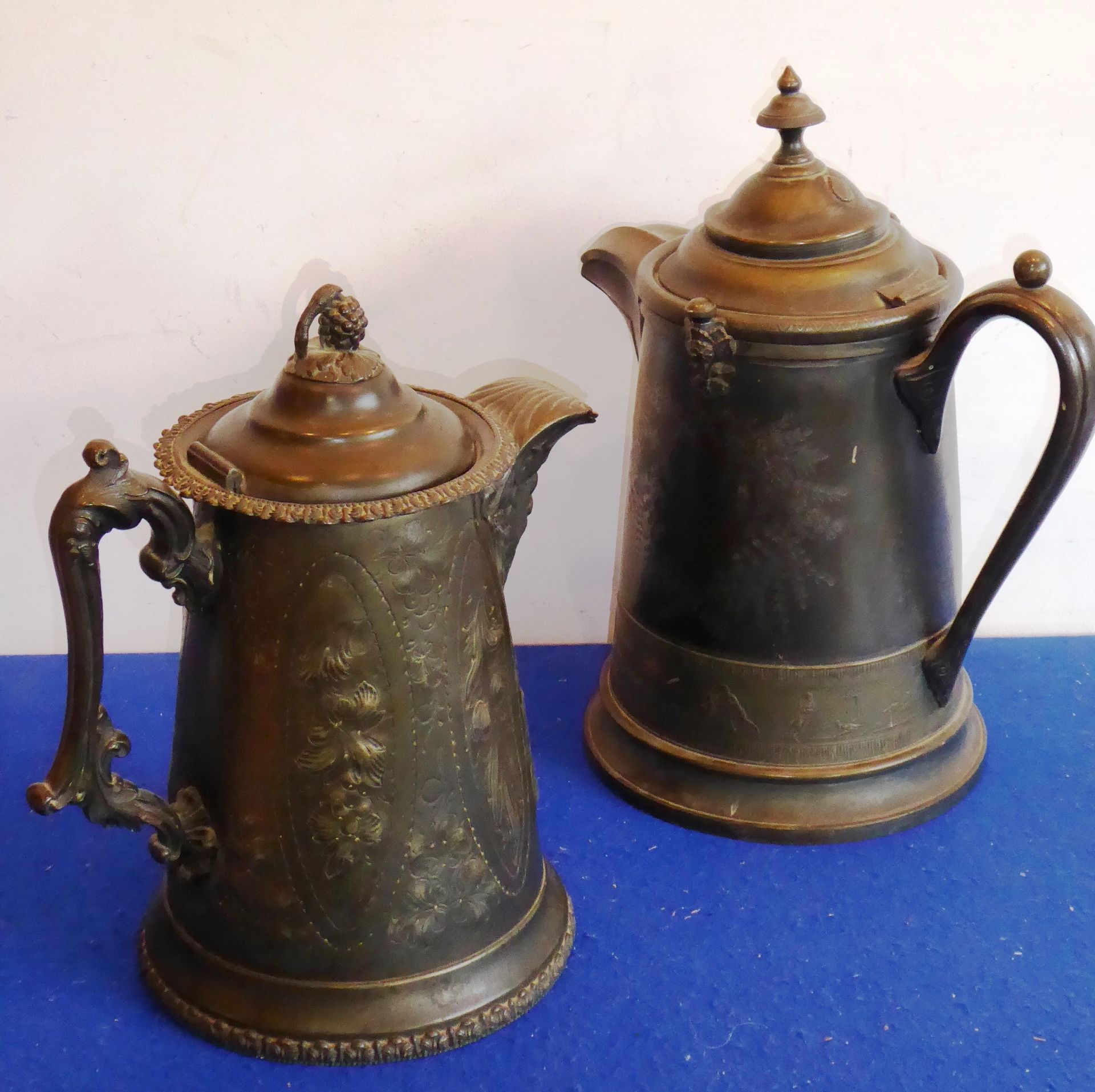 Two 19th century pewter hot water jugs (one ceramic lined);