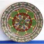 An early 20th century Royal Bonn 'Old Dutch' pattern wall hanging charger hand-decorated in enamels,