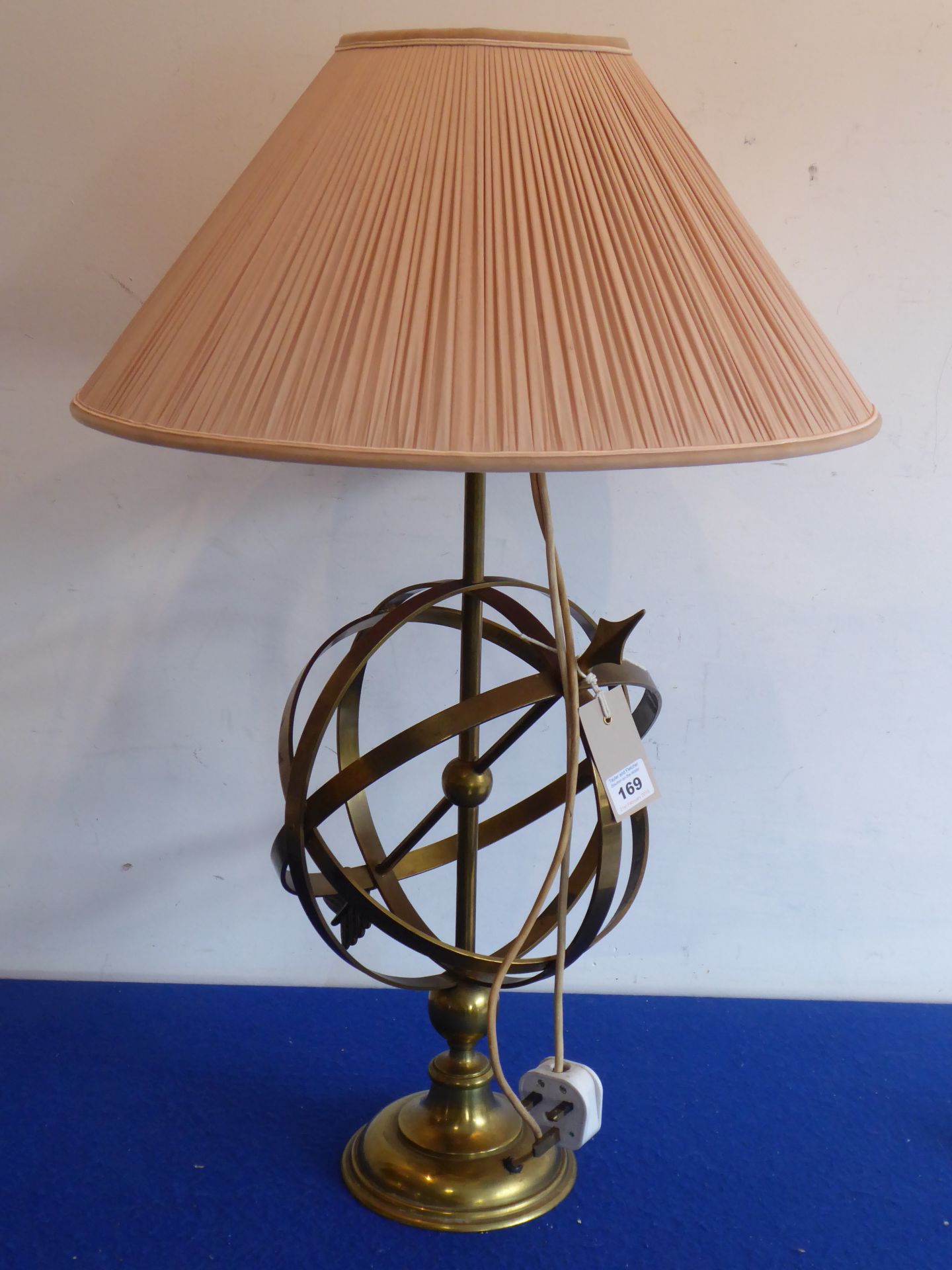 A brass table lamp unusually modelled as an armillary sphere (with shade),