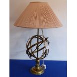 A brass table lamp unusually modelled as an armillary sphere (with shade),