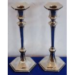 A pair of early 20th century hallmarked silver hexagonal table candlesticks, London assay marks,