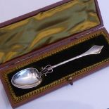 A cased hallmarked silver Arts and Crafts style spoon,