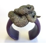 A large stingray skin and silver snake bangle set with multi Swarovski crystals