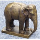 A cast bronze elephant standing four square (modern), raised on plinth base, 20cm long x 18.