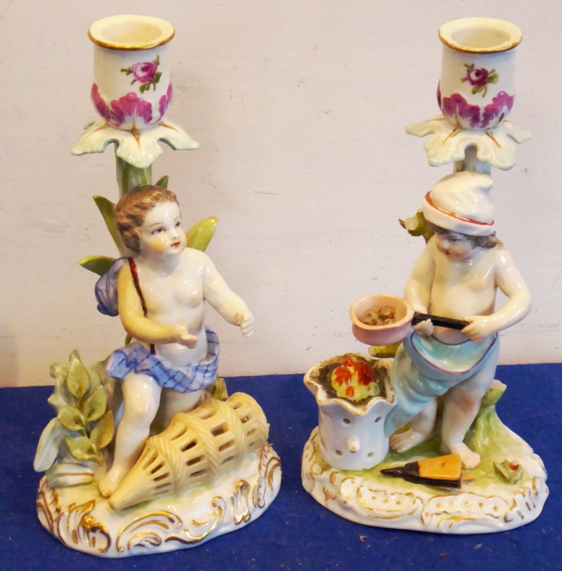 A pair of late-19th / early-20th century German figural porcelain candlesticks modelled as