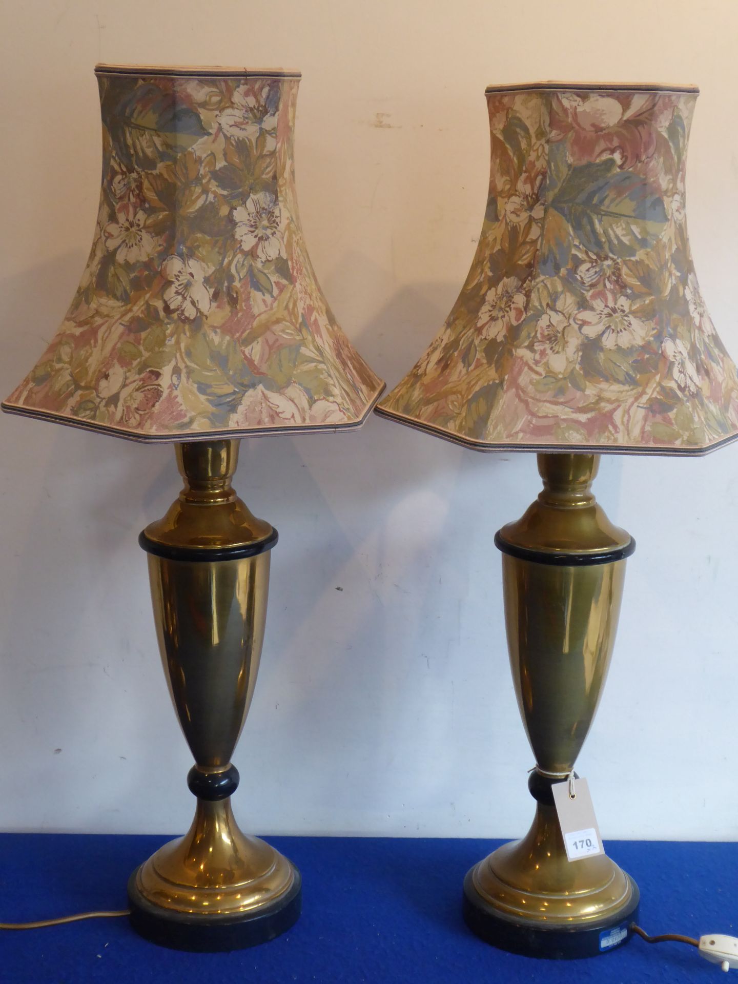 A pair of tall baluster-shaped brass table lamps;